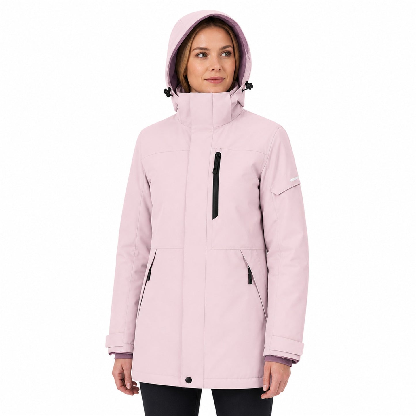 Woman wearing the Blush Pink Derwent jacket fully zipped with hood up