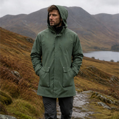 Man wearing the Lowther Military Green longline hooded jacket outdoors in Britain