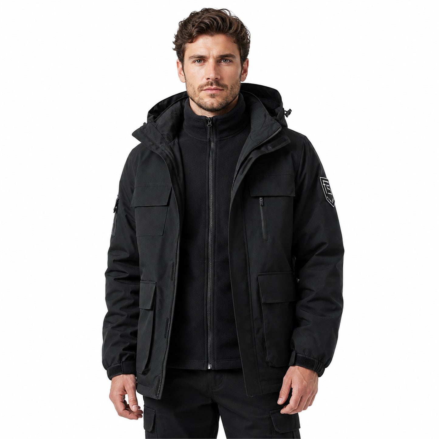 Man wearing black Tamar jacket open over zipped fleece