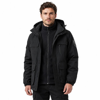 Man wearing black Tamar jacket open over zipped fleece